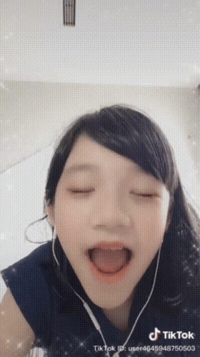 Girl In Headphones Making Funny Face GIF
