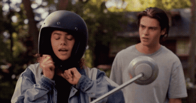 Girl In Helmet Standing Next To Man GIF