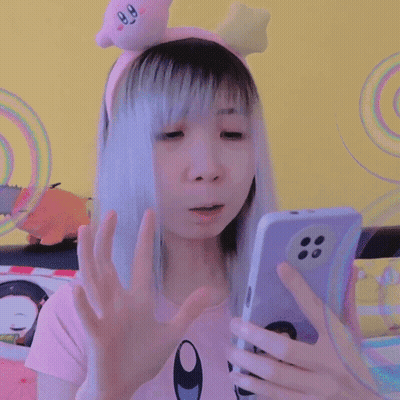 Girl In Kirby Headband Looking At Phone GIF