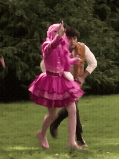 Girl In Pink Dress Dancing With Man In Varsity Jacket GIF