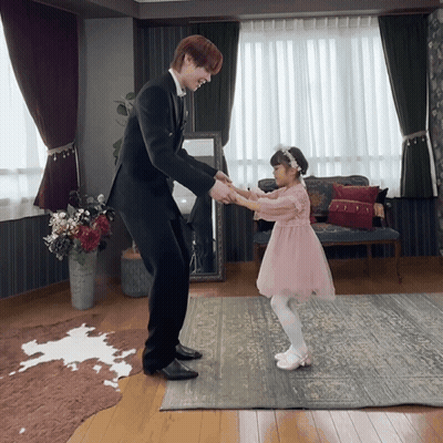 Girl In Pink Dress Holding Hands With Man In Suit GIF
