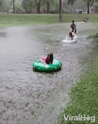 Girl In Pink Dress Riding Green Inner Tube GIF