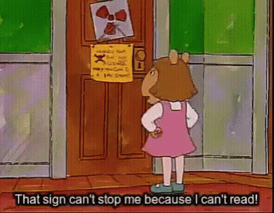 Girl In Pink Dress Standing In Front Of Door With Sign That Can't Stop Me GIF