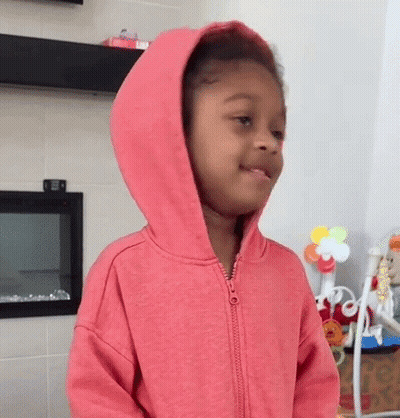 Girl In Pink Hoodie Standing In Room GIF