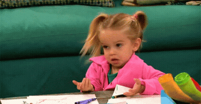 Girl In Pink Jacket Drawing With Crayons GIF