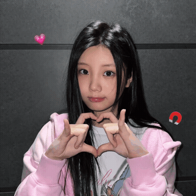 Girl In Pink Jacket Making Heart Shape GIF