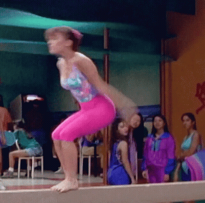 Girl In Pink Jumping On Balance Beam GIF