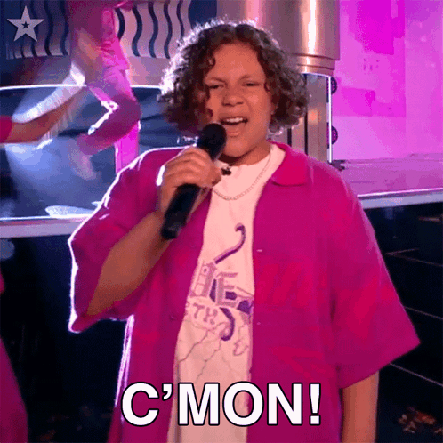 Girl In Pink Shirt Singing Into Microphone With C'mon GIF