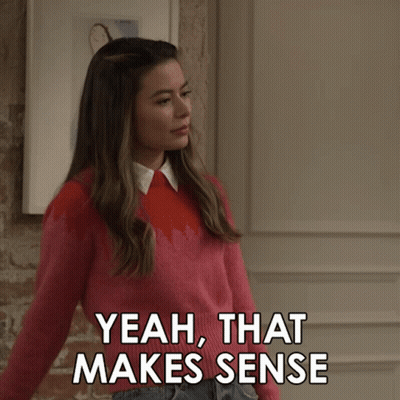 Girl In Pink Sweater Pointing Yeah That Makes Sense GIF