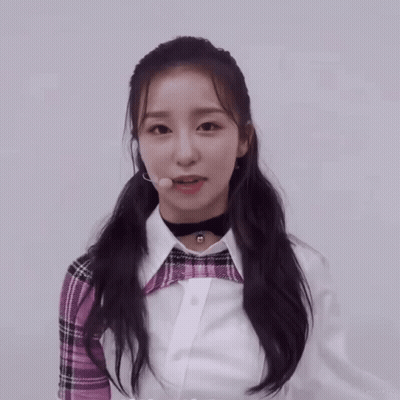 Girl In Plaid Shirt And Choker Looking At Camera GIF