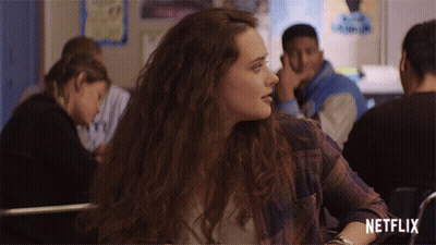 Girl In Plaid Shirt Sits In Classroom With Netflix Logo GIF