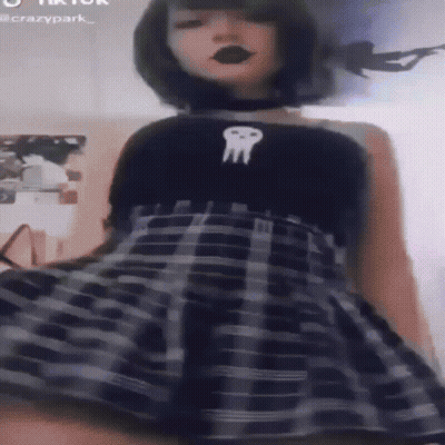 Girl In Plaid Skirt And Black Skull Top GIF