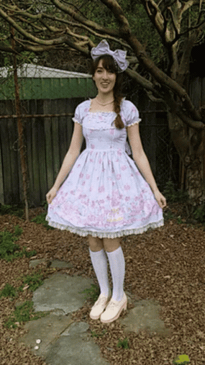 Girl In Purple Dress With Pink Flowers And White Socks GIF