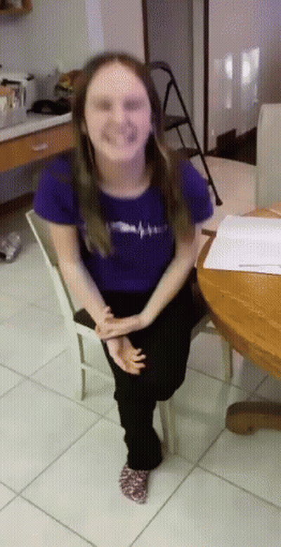 Girl In Purple Shirt Sitting On White Chair GIF