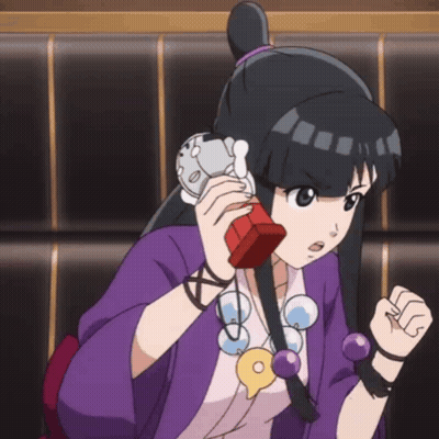 Girl In Purple Shirt Talking On Red Phone GIF