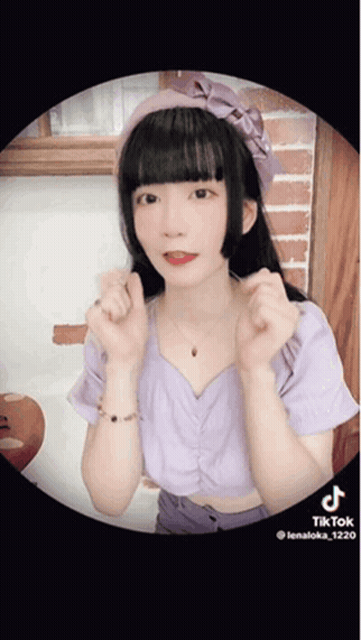 Girl In Purple Top With Pink Headband Making Heart Shape GIF