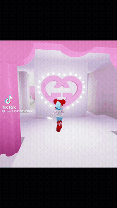 Girl In Red Hat Standing Before Pink Heart With G GIF