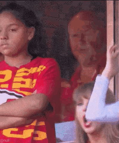 Girl In Red Shirt Number 25 Next To Woman In Blue Shirt GIF