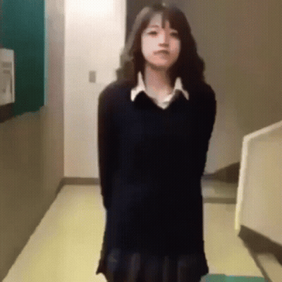 Girl In School Uniform Crossing Arms In Hallway GIF