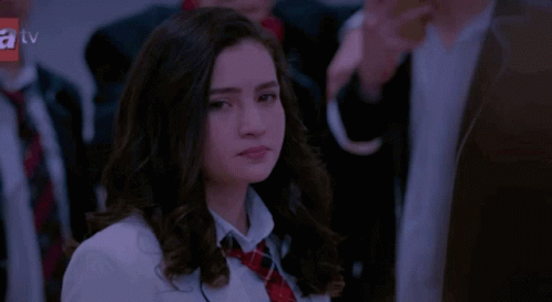 Girl In School Uniform Looking At Camera GIF