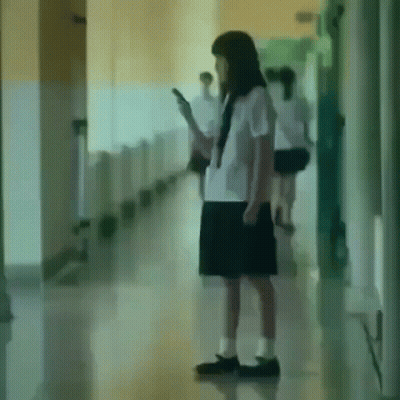 Girl In School Uniform Looking At Cell Phone GIF