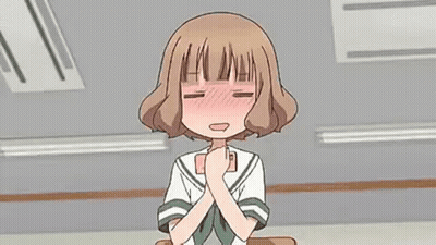 Girl in School Uniform Sitting at Desk With Hands Folded
