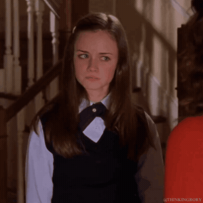 Girl In School Uniform Standing In Front Of Stairs GIF