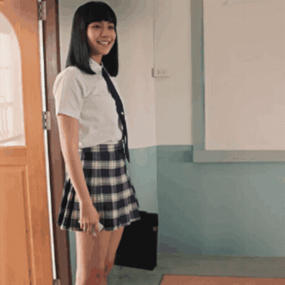 Girl In School Uniform Standing In Front Of Whiteboard GIF