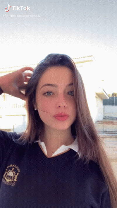 Girl In School Uniform Taking Selfie Hand In Hair GIF