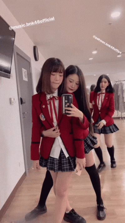 Girl In School Uniform Taking Selfie In Mirror GIF