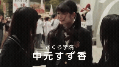 Girl In School Uniform Talking To Girl With Chinese Writing GIF