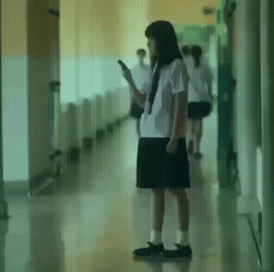 Girl In School Uniform Using Cell Phone GIF
