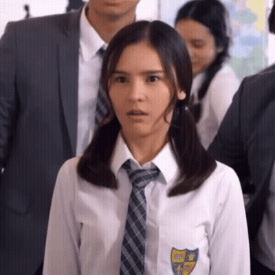 Girl In School Uniform With Pigtails And Tie Standing In Crowd GIF
