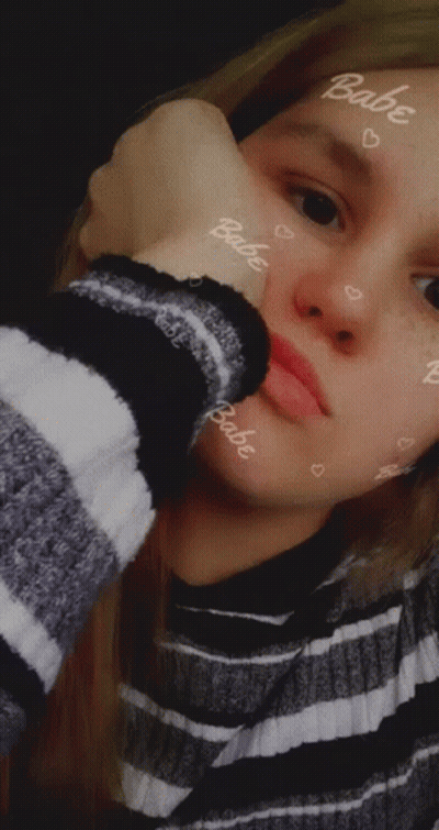 Girl In Striped Sweater With Babe On Face GIF
