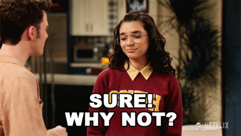 Girl In Sweater Saying Sure Why Not GIF