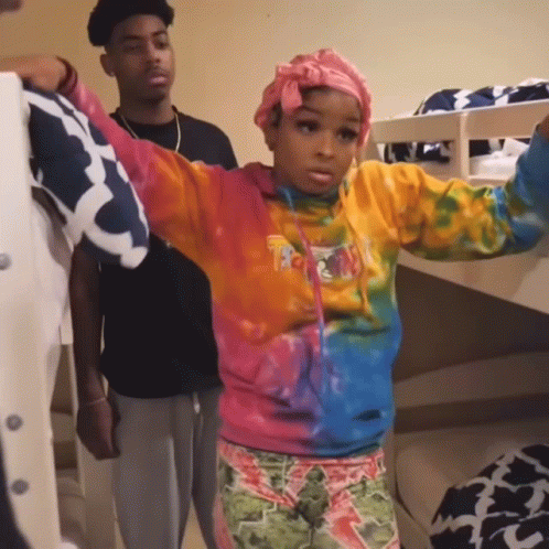 Girl in Tie Dye Sweatshirt Next to Bunk Bed