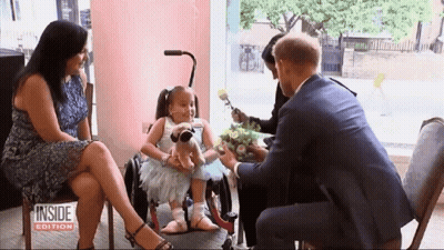 Girl In Wheelchair Receiving Flowers GIF
