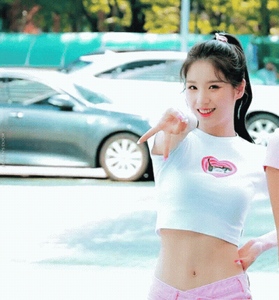 Girl in White Crop Top and Pink Shorts Pointing