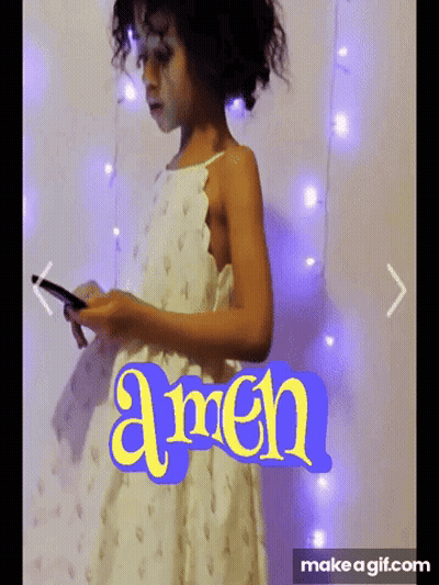 Girl In White Dress Holding Phone In Front Of Amen Wall GIF