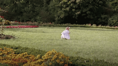 Girl In White Dress Runs In Grassy Field GIF