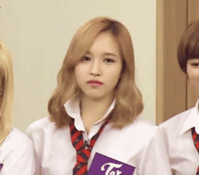 Girl In White Shirt And Tie Holding Tor Book GIF