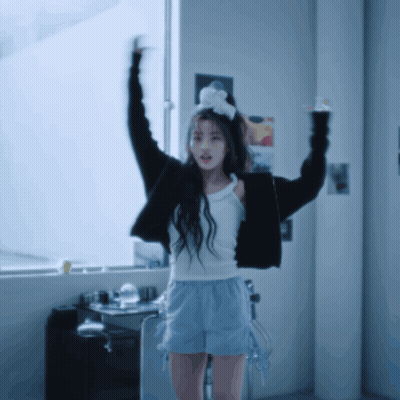 Girl In White Tank Top And Shorts With Arms Up GIF