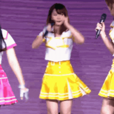 Girl In Yellow Skirt Holding Microphone GIF