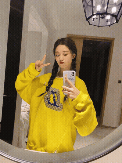 Girl in Yellow Sweatshirt Taking Selfie