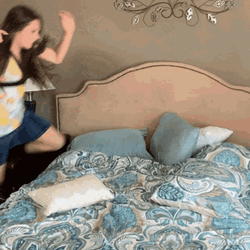 Girl Jumping On Her Bed GIF