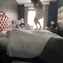 Girl Jumping On The Bed In Towel GIF