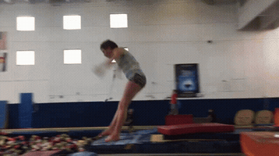 Girl Jumping On Trampoline In Gym GIF