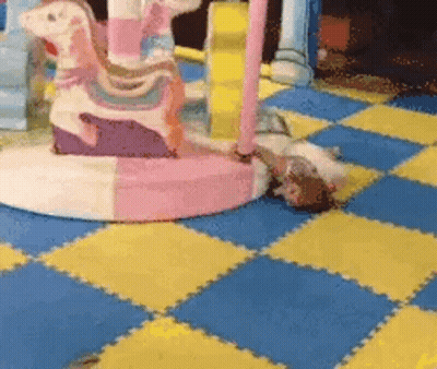 Girl Laying in Front of Carousel Horse