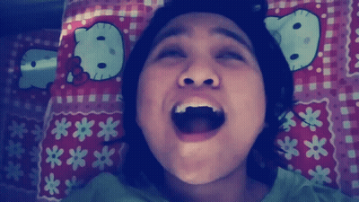 Girl Laying On Bed With Hello Kitty Pillow GIF