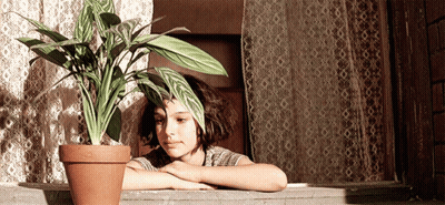 Girl Leaning On Window Sill With Plant GIF